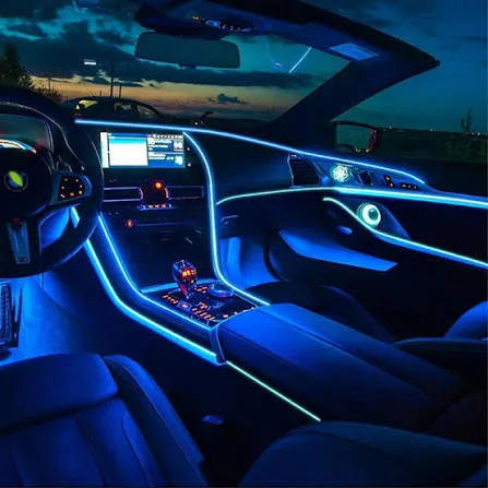 Ambient lighting tracing the door panels and console of a vehicle interior