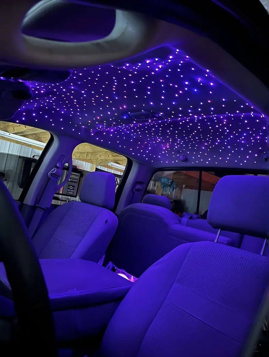 Close-up of individual fiber-optic star tips in a custom starlight headliner