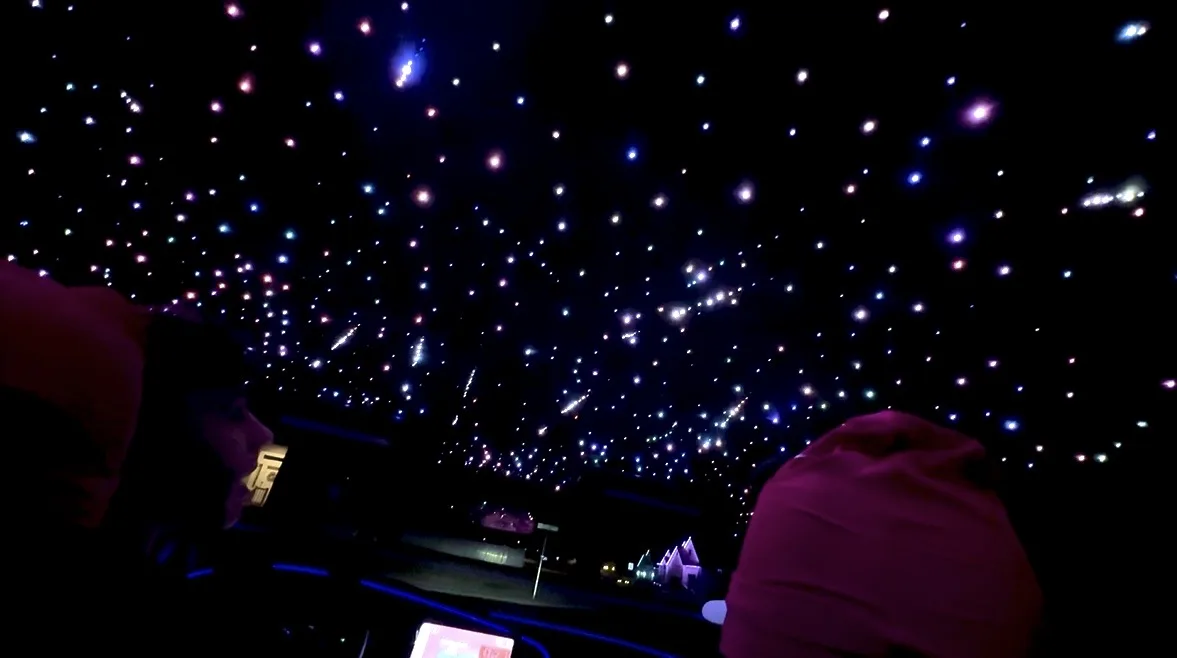 Multicolor starlight headliner glowing inside a vehicle at night