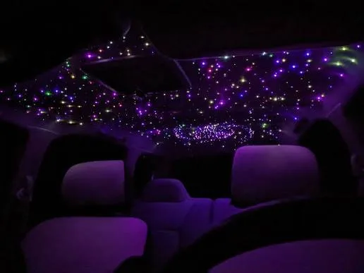 Fiber-optic starlight headliner glowing in purple across a vehicle ceiling