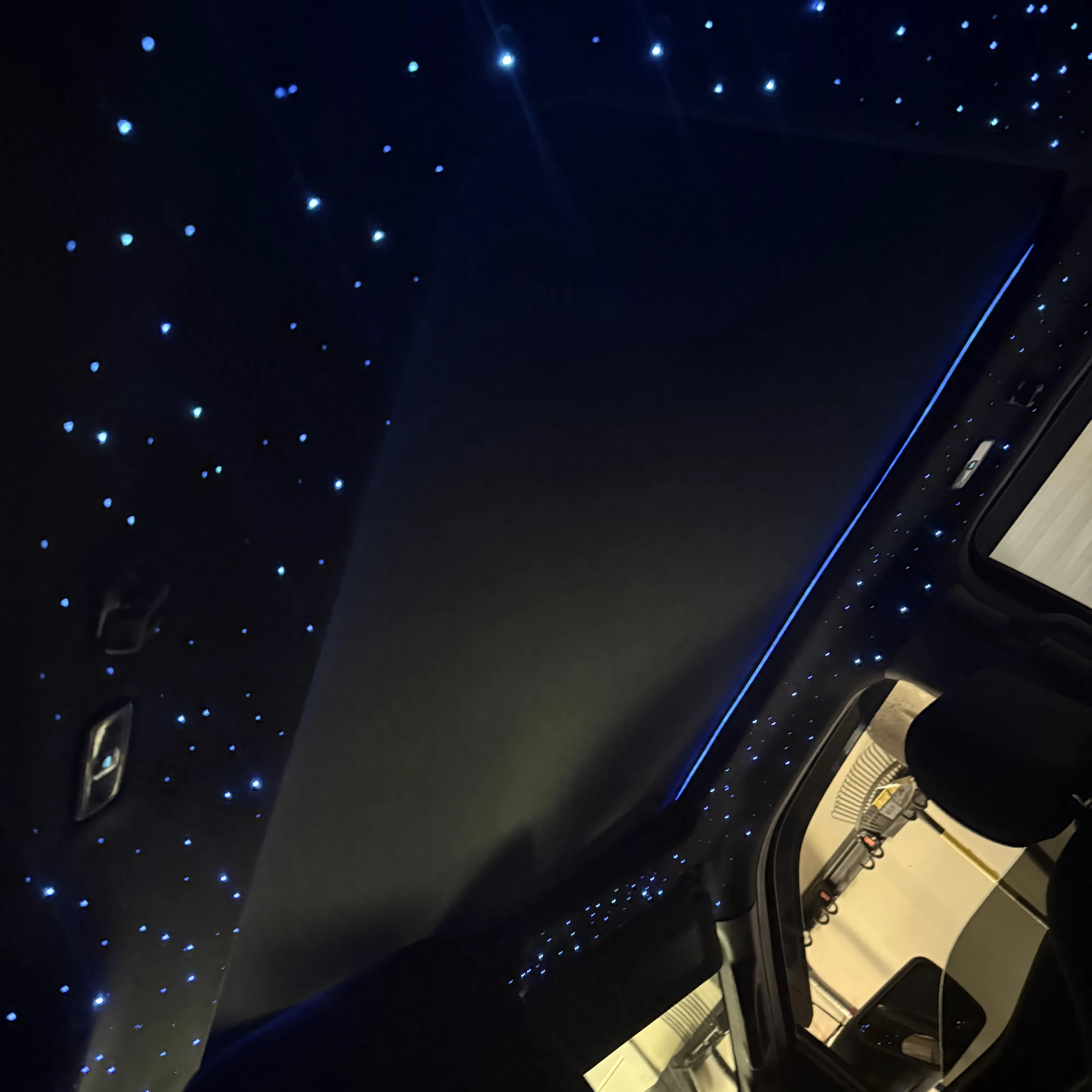 Truck starlight headliner with blue ambient strip along the roof edge