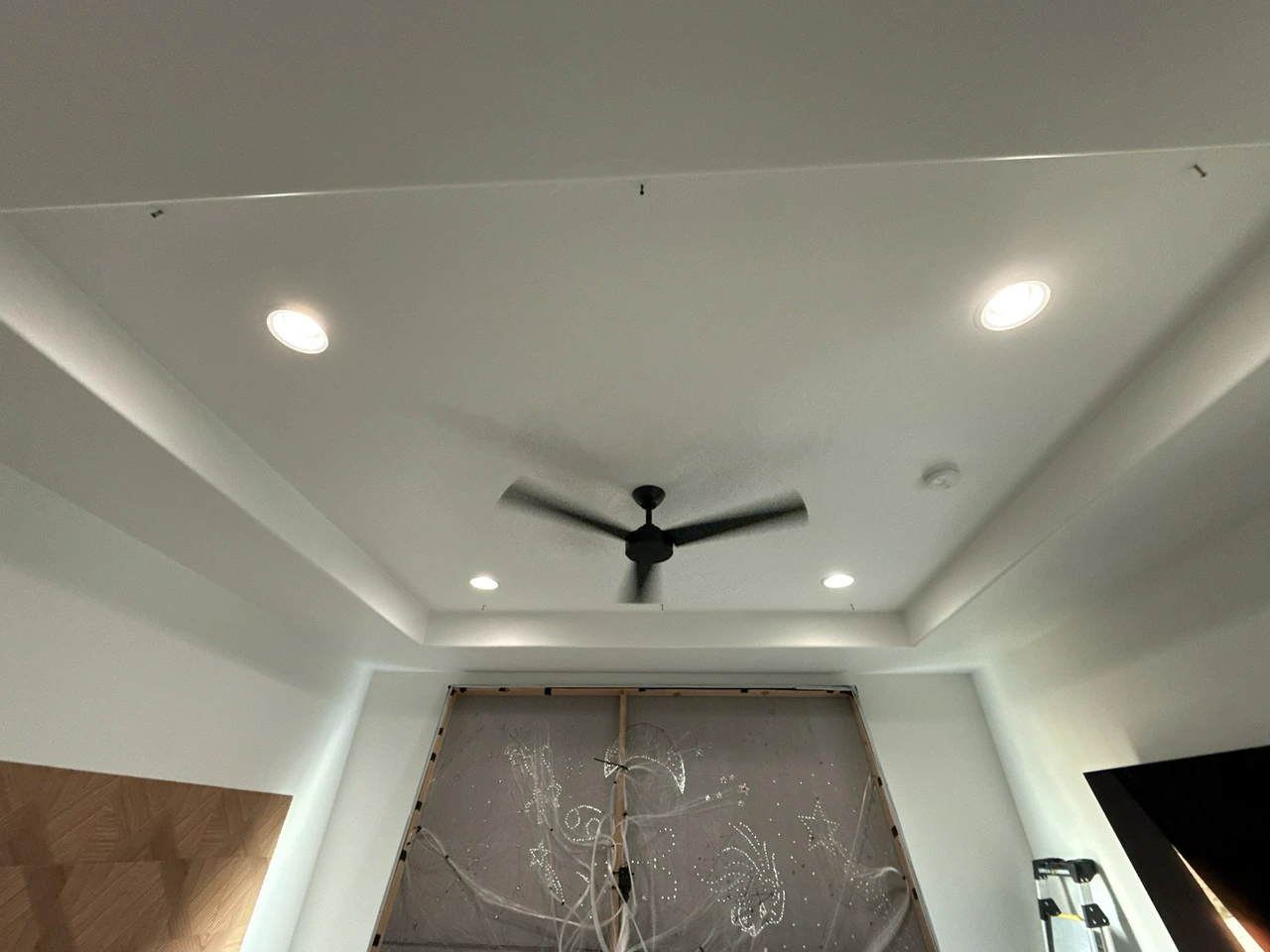 Plain ceiling before starlight panel installation, with the star panel prepped below